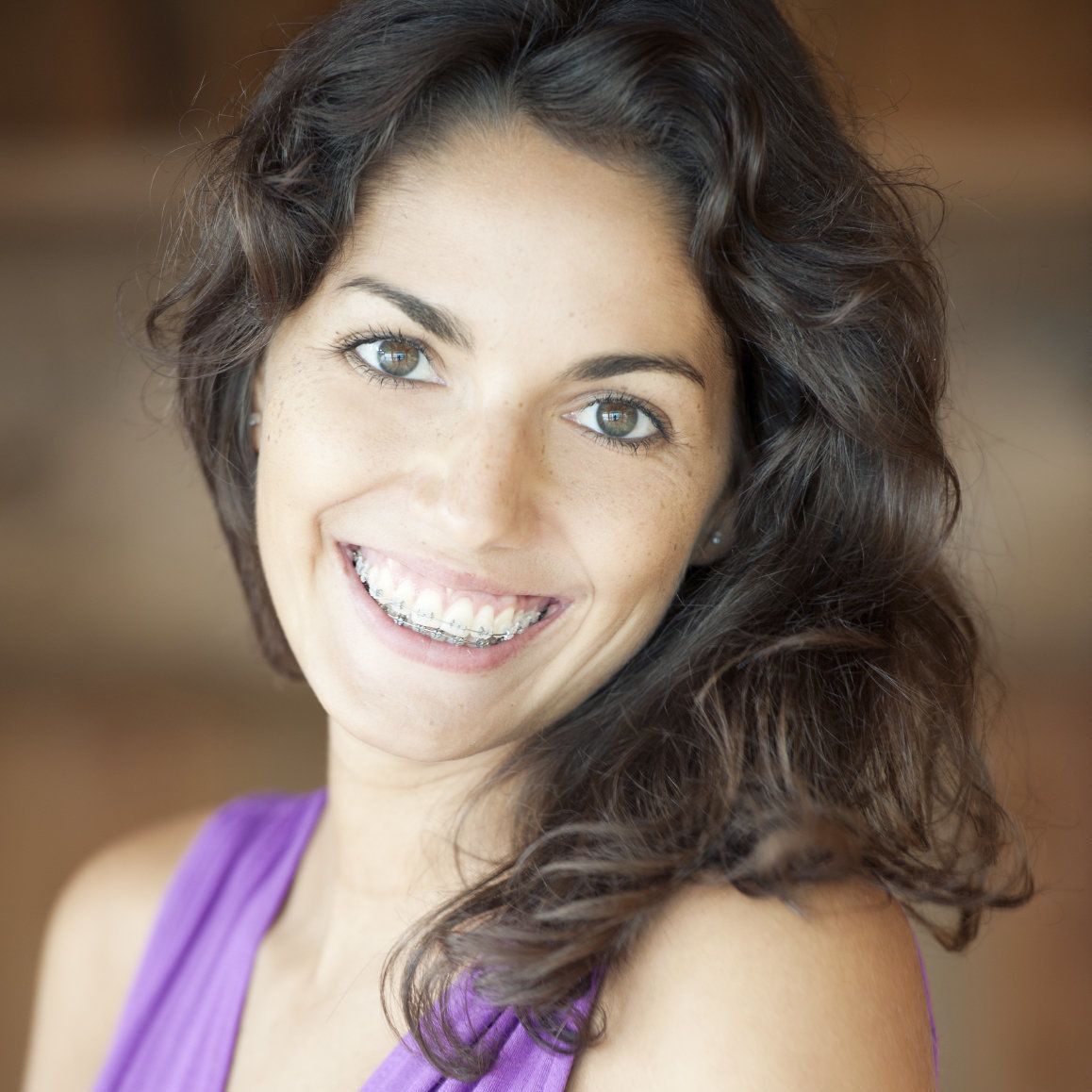 Smiling brunette in braces